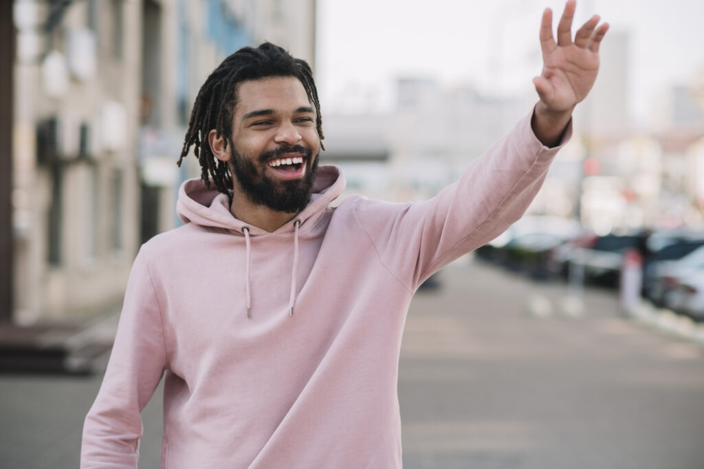 cheerful-man-waving-hand-medium-shot