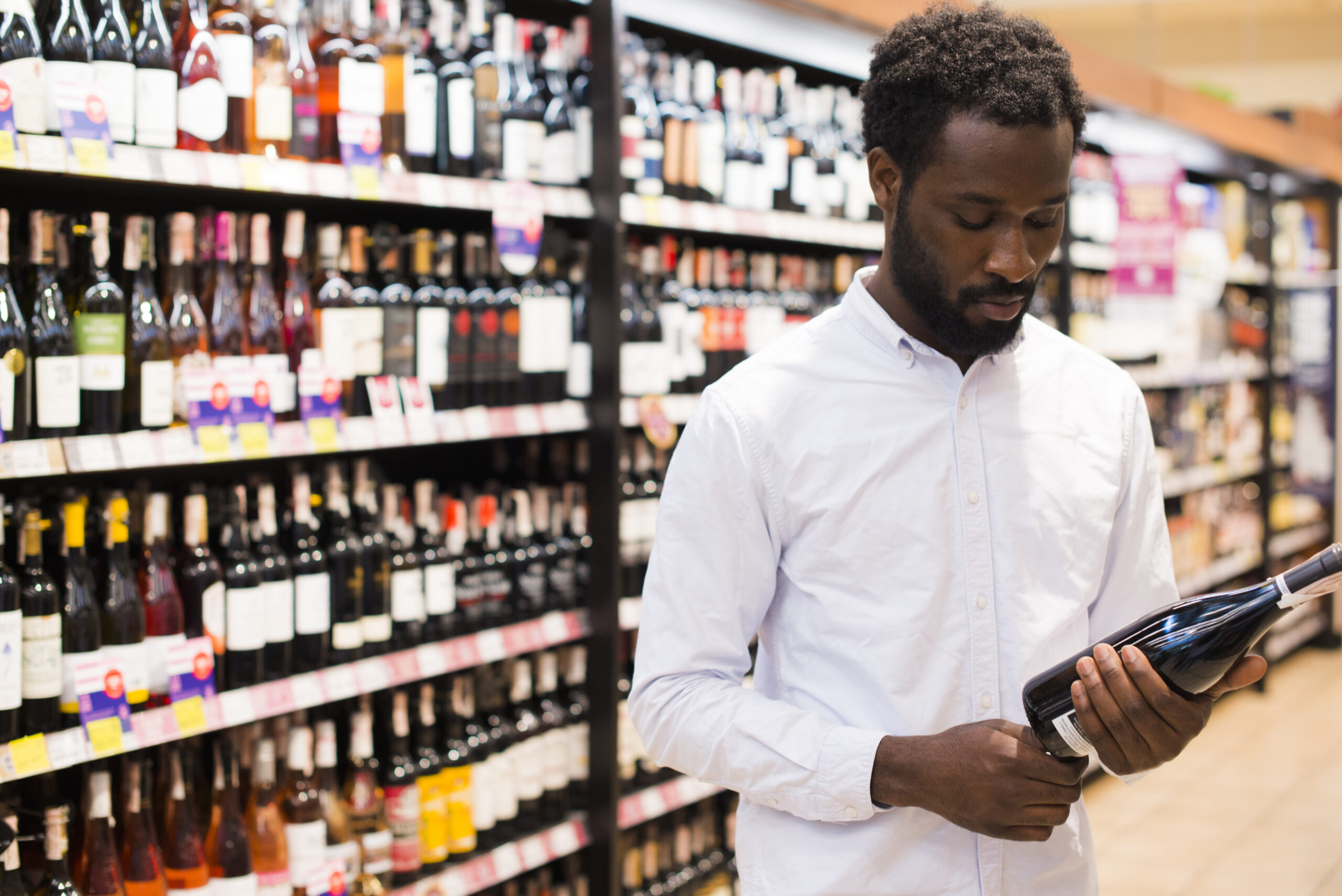 A man shopping for Shoprite liquor specials.